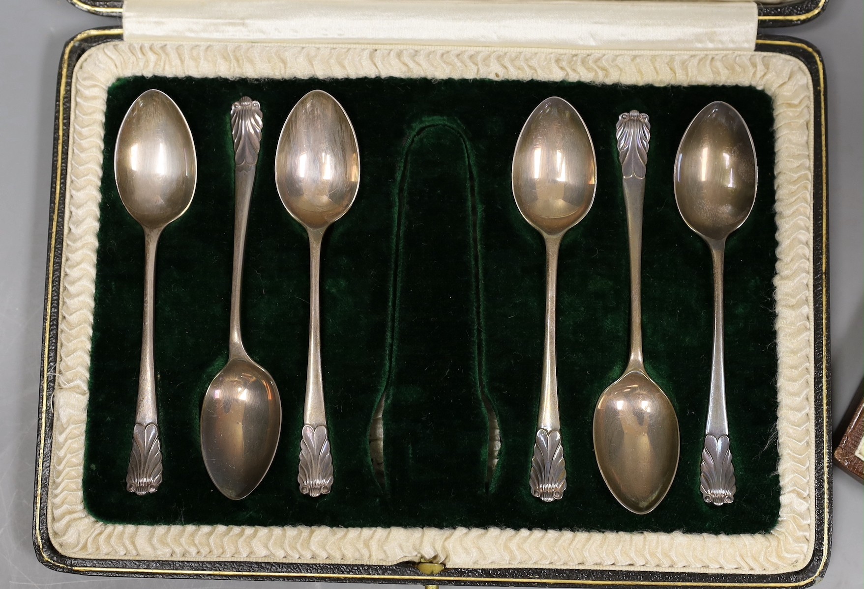A cased set of six George V silver and enamel coffee spoons, Henry Clifford Davis, Birmingham, 1927, 95mm and a similar set of six silver coffee spoons.
